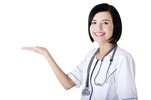 Mujer médica joven presentando y mostrando espacio de copia — Foto de Stock