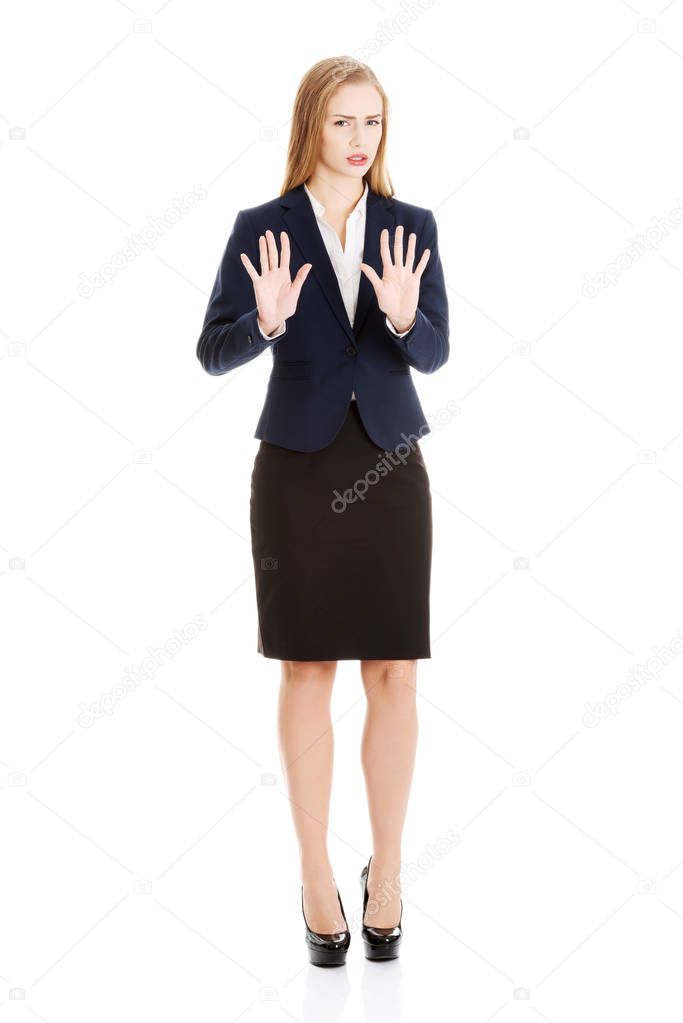 Beautiful caucasian business woman is showing refusing, rejecting gesture.