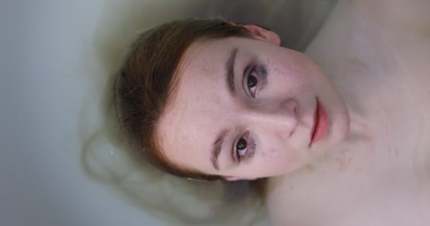 Closeup of a beautiful woman half under water — Stock Video