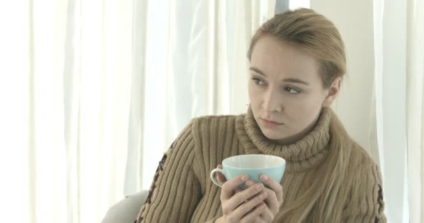 Portrait of a woman relaxing at home with a cup of tea — Stock Video