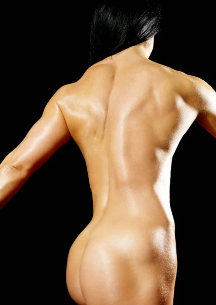 Muscular mulher fisiculturista mostrando seus músculos . — Fotografia de Stock
