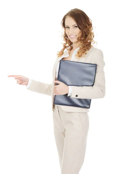 Happy businesswoman pointing with clipboard. — Stock Photo, Image