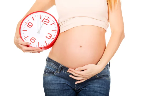 Femme enceinte avec horloge — Photo