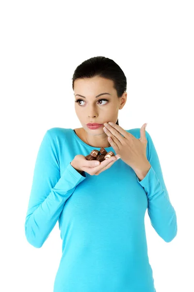 Woman eating chocolates — Stock Photo, Image