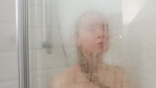 Blurred view of woman under shower — Stockvideo