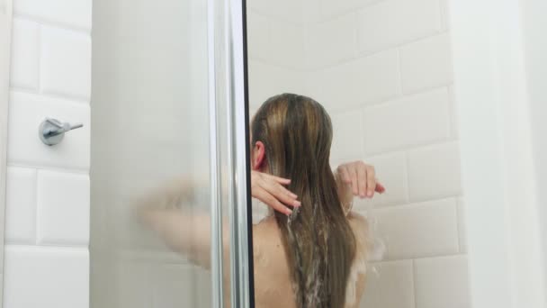 Back view of woman under shower — Stockvideo