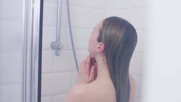 Woman under shower, back view — 비디오