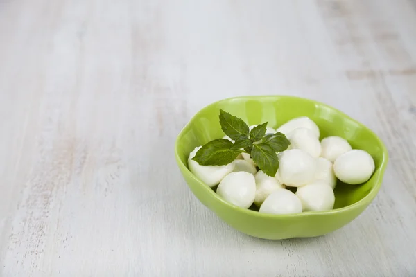 Mozzarella in a green plate — Stock Photo, Image