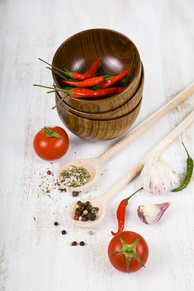 Vegetables and spices in wooden bowls — Stock Photo, Image