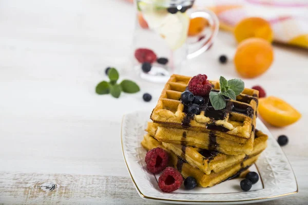 Belgian waffles with raspberries, blueberries and mint, covered — Stock Photo, Image