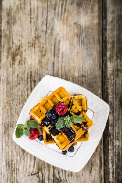 Belgian waffles with raspberries, blueberries and mint, covered — Stock Photo, Image
