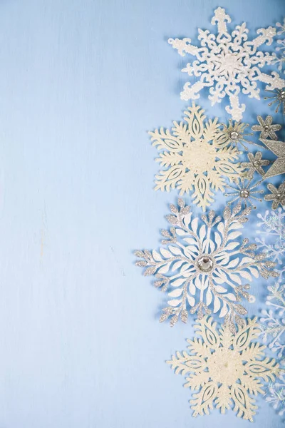 Flocos de neve decorativos prateados em um fundo de madeira azul. Cristo. — Fotografia de Stock