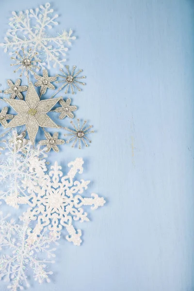 Flocons de neige décoratifs en argent sur un fond en bois bleu. Jésus Christ — Photo