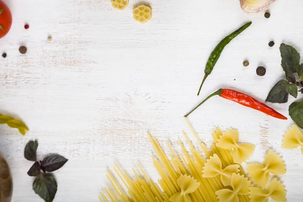 Raw pasta and spices in wooden table. Pasta and ingredients: chi — Stock Photo, Image