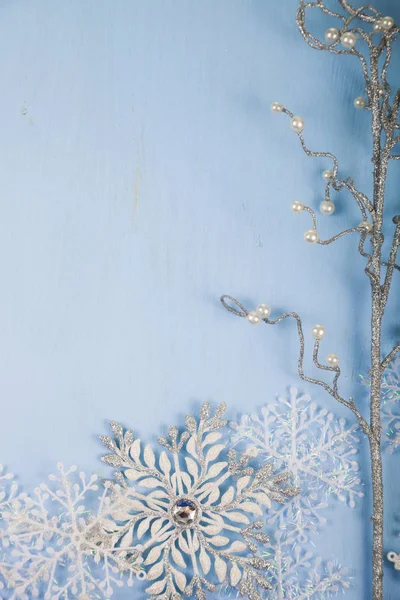 Silver decorative snowflakes and branch on a blue wooden backgro — Stock Photo, Image