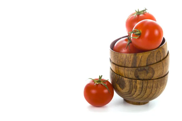 Ripe tomatoes in wooden bowls on a white background — Stock Photo, Image