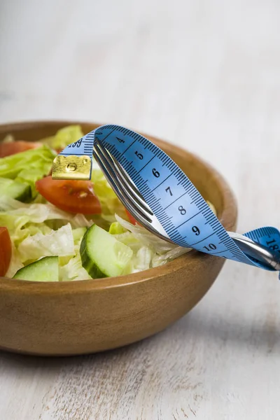 Salad in wooden bowl on a table close-up. — Stock Photo, Image