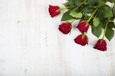 Ahşap arka planda kırmızı güller. 