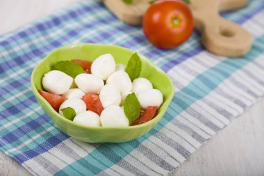 Ahşap bir masa üzerinde Caprese salatası.  