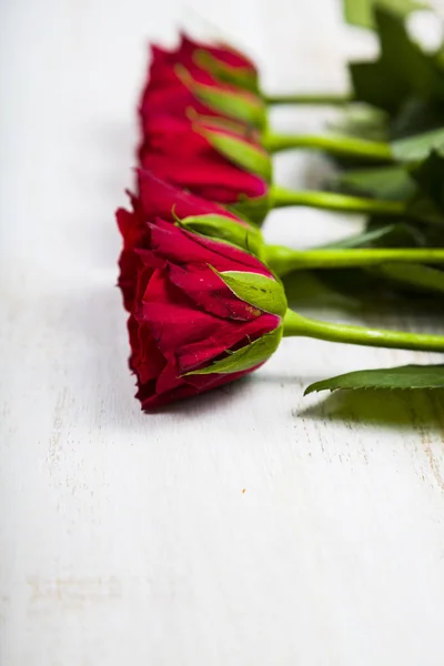 Rode rozen op een houten achtergrond — Stockfoto