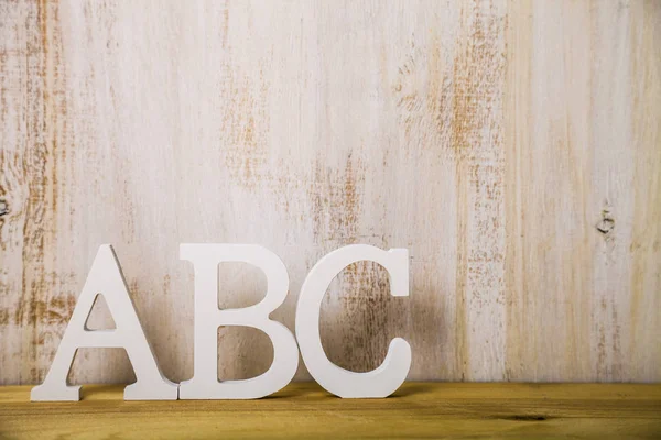 Letters "ABC" on a light wooden background — Stock Photo, Image