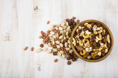 Ahşap bir masa üzerinde bir ahşap kase fındık 