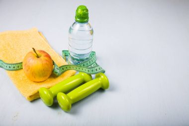 Halter, bir elma, bir havlu ve bir şişe su