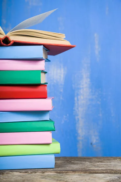 Stack of books on a blue background. — Stock Photo, Image