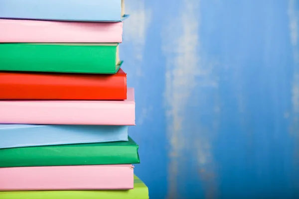 Pilha de livros em um fundo azul. — Fotografia de Stock