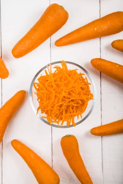 Grate  carrots in a bowl — Stock Photo, Image