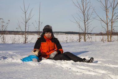 Oğlan ve köpek kış aylarında yürüyen