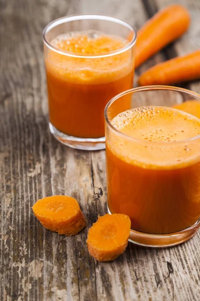 Carrot juice on a wooden table — Stock Photo, Image