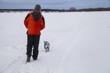 Oğlan ve köpek kış aylarında yürüyen