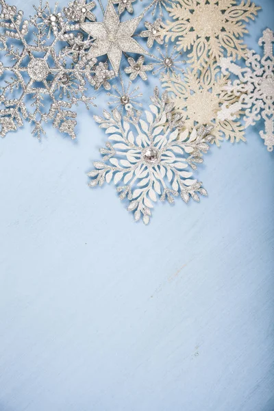 Silvery snowflakes on a  wooden background. — Stock Photo, Image