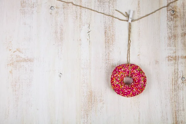 Pink donut on a rope — Stock Photo, Image