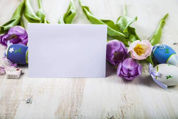 Purple tulips, paper and Easter eggs — Stock Photo, Image