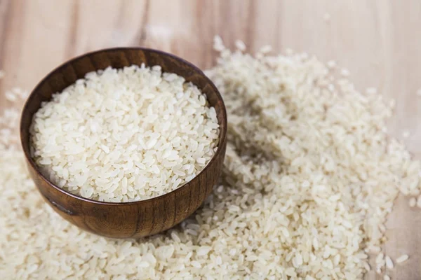 Raw rice in a wooden bowl