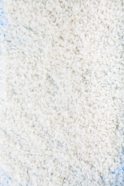 Rauwe rijst close-up, achtergrond. — Stockfoto