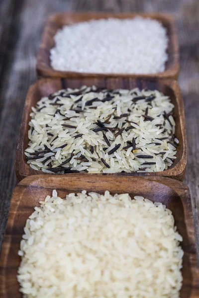 Três tigelas com diferentes variedades de arroz — Fotografia de Stock