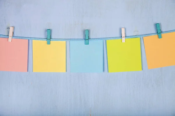 Five sheets of paper hang on a rope — Stock Photo, Image