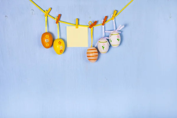 Easter Eggs and paper on a rope — Stock Photo, Image