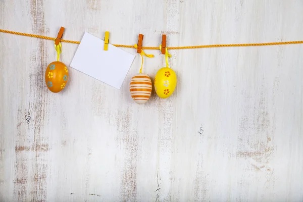 Easter Eggs and paper on a rope — Stock Photo, Image