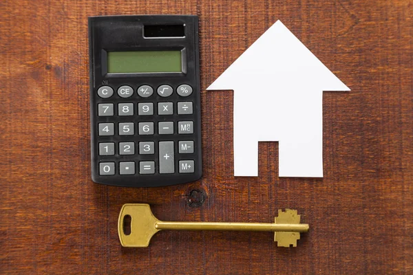 Cardboard house,calculator and key — Stock Photo, Image