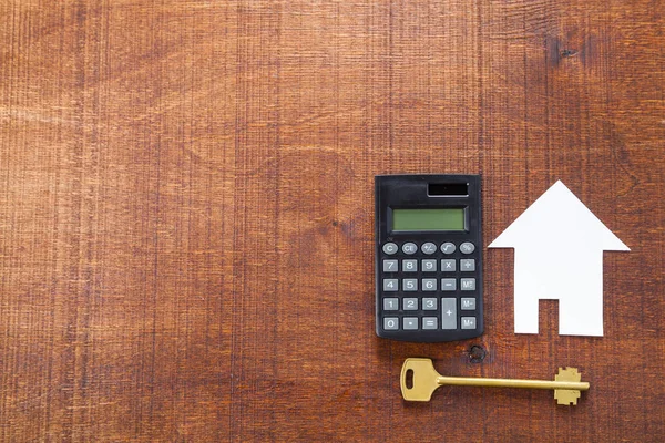 Cardboard house,calculator and key — Stock Photo, Image