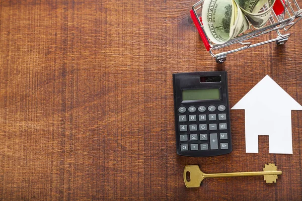 Cardboard house,calculator and keys — Stock Photo, Image