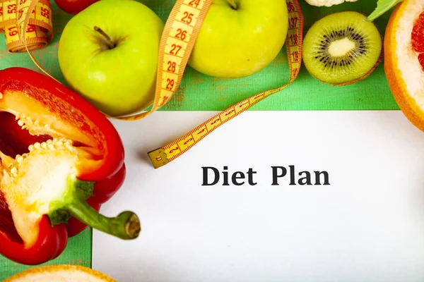 Food and sheet of paper with a diet plan — Stock Photo, Image