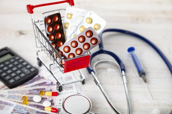 Carrito Compras Con Pastillas Dinero Calculadora Sobre Fondo Madera Medicamentos —  Fotos de Stock