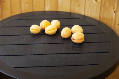 Tahta bir masada olgun kayısılar..