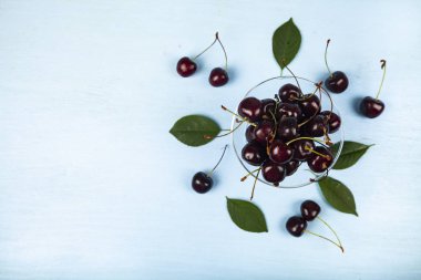 Ripe sweet cherry in a transparent bowl 