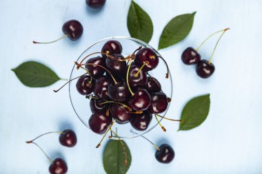 Ripe sweet cherry in a transparent bowl 